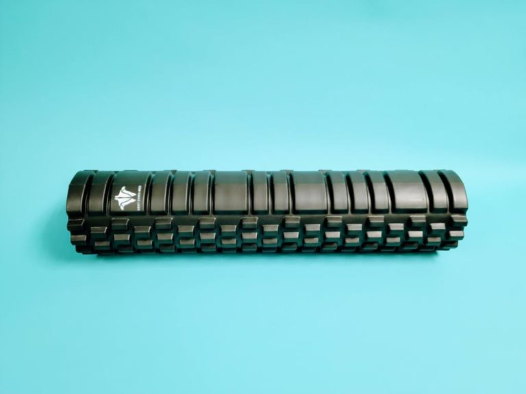 Black textured foam roller on a blue background